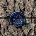 Close-up of 99 Problems strain featuring large, spade-shaped buds with bright orange hairs and frosty white trichomes, available for weed delivery in Virginia and Washington, DC. Known for its sweet berry-diesel flavor and energizing sativa effects