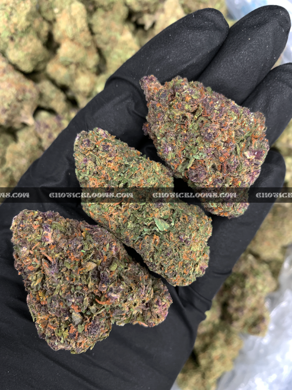 Close-up of Pink Guava strain featuring forest green buds with pink undertones, pink-orange hairs, and golden-amber trichomes, available for weed delivery in Virginia and Washington, DC. Known for its tropical guava flavor and euphoric hybrid effects.