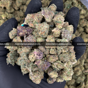 Close-up of Candy Glue strain featuring forest green grape-shaped buds with amber undertones, orange hairs, and frosty golden-white trichomes, available for weed delivery in Virginia and Washington, DC. Known for its sweet candy flavor and euphoric sativa-leaning effects.