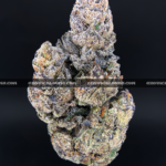 Close-up of Unicorn Tears strain flower with dark olive green buds, purple accents, and sticky trichomes – available for delivery in Washington DC and Virginia.