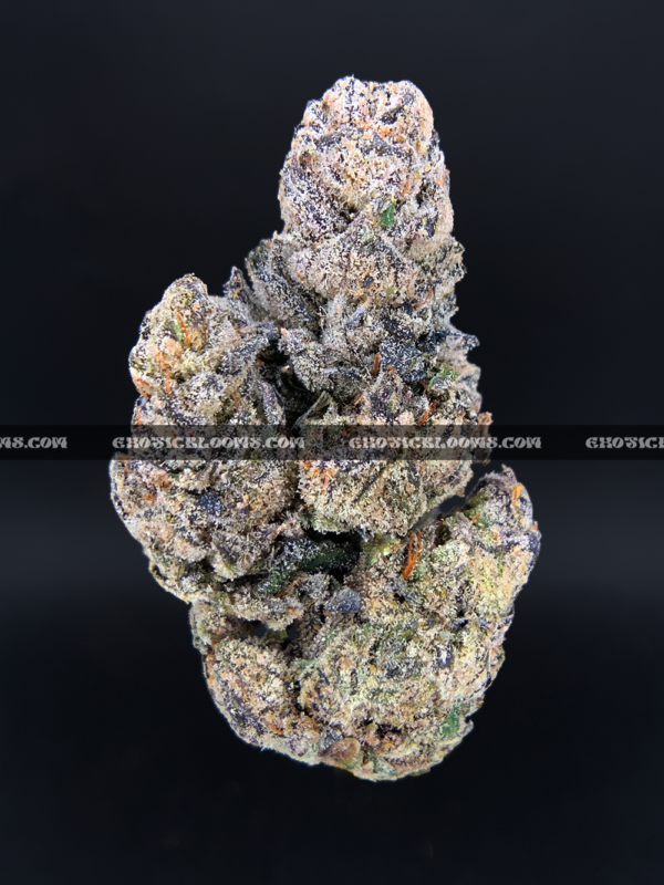 Close-up of Unicorn Tears strain flower with dark olive green buds, purple accents, and sticky trichomes – available for delivery in Washington DC and Virginia.